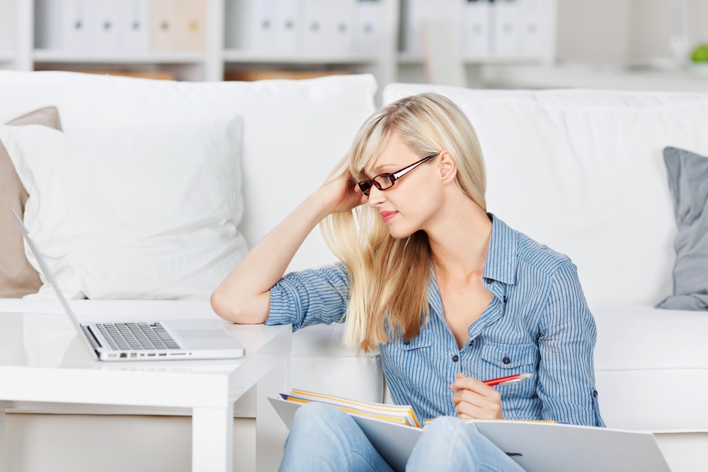 young female staring at laptop