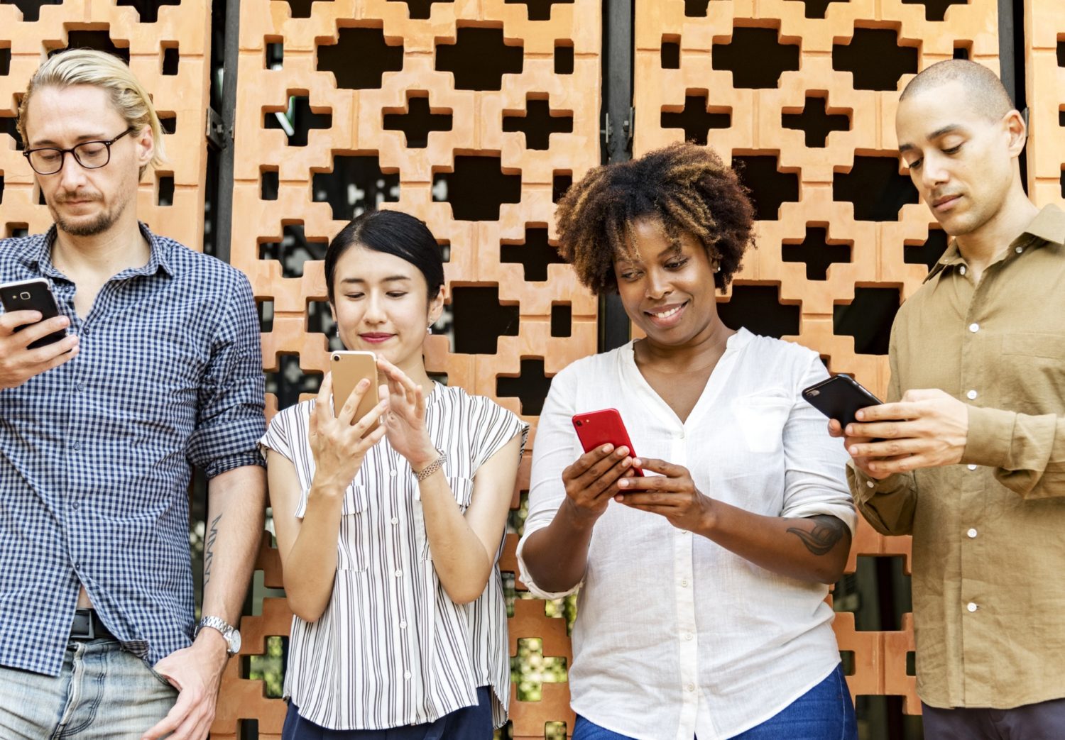 group of people standing on cell phones